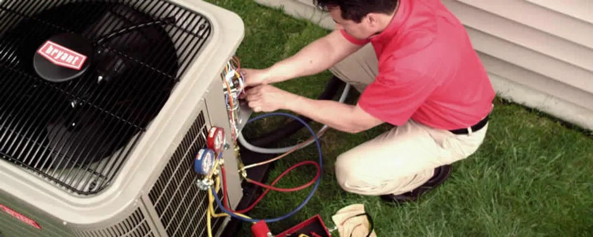 HVAC technician servicing an outdoor air conditioner unit in Beverly, MA